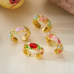 Detailed view of vintage enamel rings featuring colorful flowers and hollow vine patterns