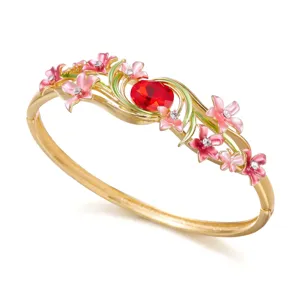 Vintage gold-plated floral bangle featuring red gemstone and pink enamel flowers
