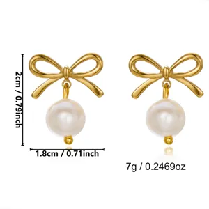 Detailed view of gold bow earrings with pearls showing measurements and weight