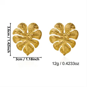 Gold vintage monstera leaf stud earrings showing 3.6cm height and 12g weight measurements