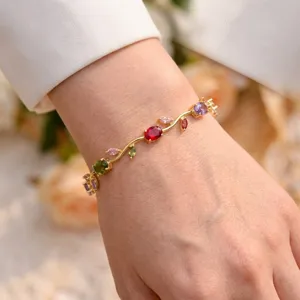 Detailed view of an elegant gold-plated vine bracelet with multi-colored crystals