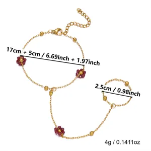 Vista dettagliata del bracciale a mano dorato con perline rosse e misure.