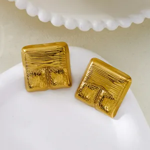 Detailed view of vintage gold-plated square earrings with unique hammered texture.