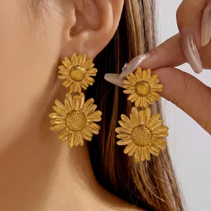 Detail shot of vintage golden double sunflower earrings in stainless steel