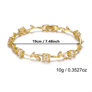Close-up of gold-plated vine leaf bracelet with yellow gemstones and dimensions