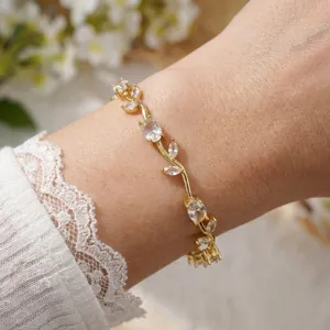 Detailed view of elegant gold-plated vine bracelet with sparkling cubic zirconia on wrist