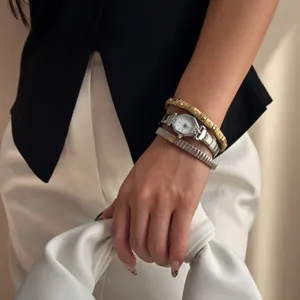 Elegant angular silver watch paired with diamond-set stretch bracelets for women