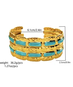 Detailed view of a gold-plated cuff bracelet featuring turquoise enamel and measurements