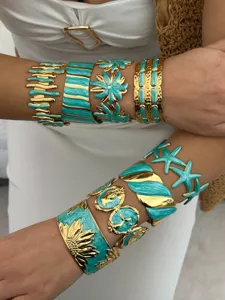 Detailed view of vintage gold stainless steel bracelets with turquoise enamel accents.