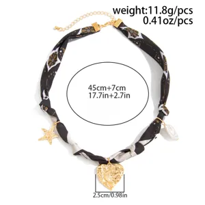 Detailed view of vintage leopard print scarf necklace with gold lava heart charm.