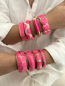 Set of dopamine style rose pink enamel bracelets with gold-tone heart and grid designs