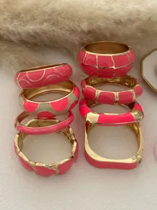 Variety of rose pink enamel bracelets with gold-plated geometric and heart patterns