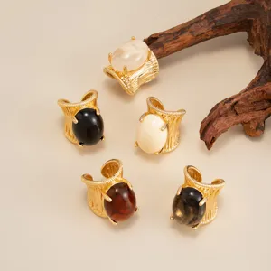Macro detail view of vintage hip hop gold rings with various colorful oval resin stones