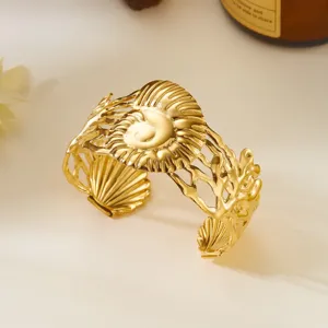 Vista dettagliata dei complessi motivi dorati a conchiglia e corallo su questo bracciale.