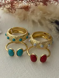 Vintage gold bracelets with turquoise and red stone inlays, detailed bohemian style.