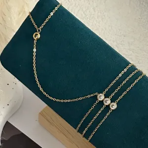Detail of dainty gold-plated copper bracelet featuring sparkling round cubic zirconia stones.