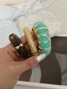Detailansicht von drei trendigen Armreifen in Gold, Mintgrün und edler Schildpatt-Optik