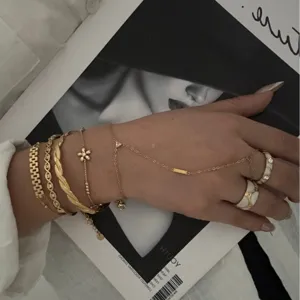 Elegant stackable gold-plated copper bracelet set with zircon flower and hand chain