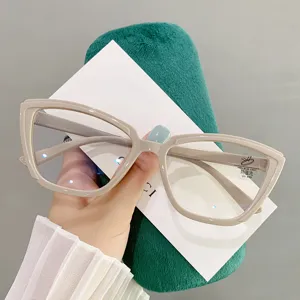Macro view of stylish beige cat-eye glasses showing anti-blue light lens coating.
