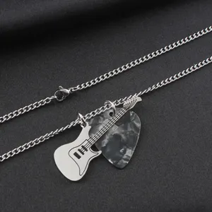 Macro shot of a stainless steel guitar charm and marbled pick pendant on a chain