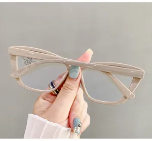 Close-up view of elegant beige cat-eye glasses with protective anti-blue light lenses.