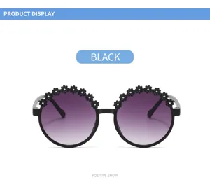 Front view of black children's round flower sunglasses with purple gradient lenses