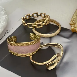Detailed view of luxury gold bangle bracelet set with unique pink marble inlay