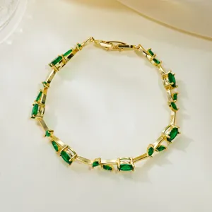 Exquisite detail of gold-plated vine bracelet with emerald green marquise crystals