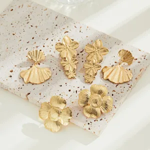 Close-up detail of vintage gold floral and ginkgo leaf stainless steel earring set.