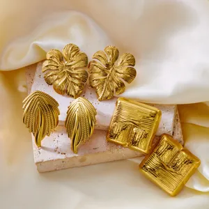 Vintage stainless steel earring set with gold monstera leaf and textured square designs