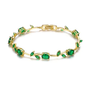 Gold-plated vine bracelet featuring emerald green gemstones and leaf design