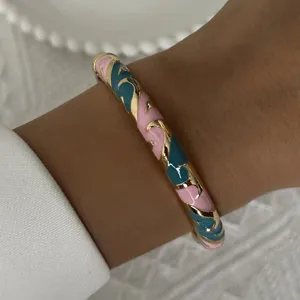 Vintage enamel bangle bracelet with pink and teal flame patterns in gold finish