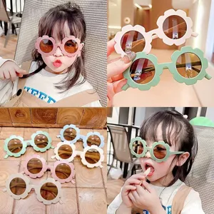 Close-up of children's flower-shaped sunglasses in multiple colors and model view