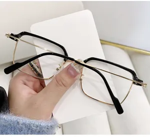 Detailed close-up of retro browline square eyeglass frame in sleek black and gold metal
