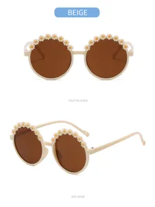 Detail view of round beige children's sunglasses with cute floral daisy decorations