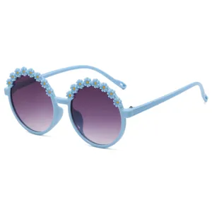 Round blue children's sunglasses decorated with cute daisy flower appliques
