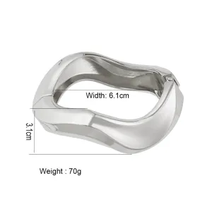 Close-up of polished silver alloy bangle featuring wavy design with 6.1cm inner width