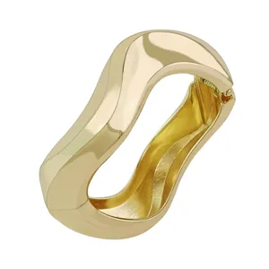 Detailed view of a gold polished wavy bangle with a minimalist hinged design.