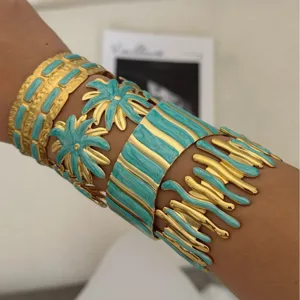 Vintage gold-plated stainless steel cuff set with turquoise enamel floral designs