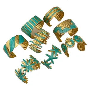Vintage gold-plated stainless steel open cuff bangles with turquoise enamel floral motifs.