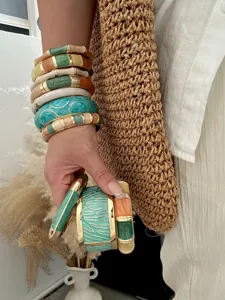 Detailed view of bohemian colorful enamel drip oil bangles with elegant gold-tone accents