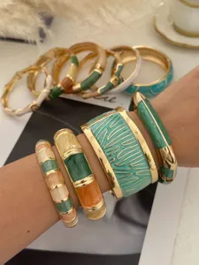 Detailed view of colorful Bohemian enamel bangles with handmade oil drop on a wrist