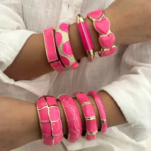 Hot pink enamel bangles with gold-toned borders in a vibrant dopamine style jewelry set.