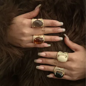 Vintage chunky gold textured rings with multi-color resin stones on fur background