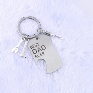 Close-up of 'BEST DAD EVER' laser-engraved stainless steel keychain with mini tool charms