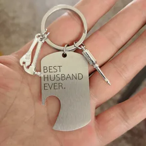Close-up of stainless steel bottle opener keychain with 'Best Husband Ever' engraving.