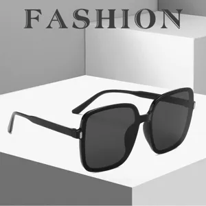 Detailed view of black oversized square sunglasses with silver rice stud accents