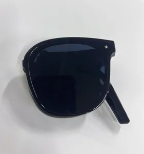 Close-up detail of black foldable UV protection sunglasses in a compact folded state