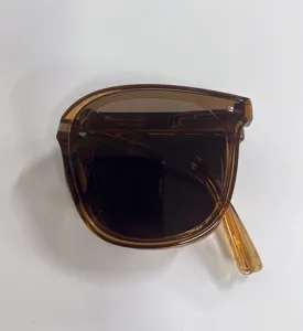 Macro view of brown foldable sunglasses showcasing the compact and portable folded design