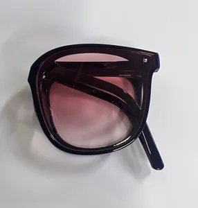 Foldable oversized sunglasses with pink gradient lenses shown in a folded state